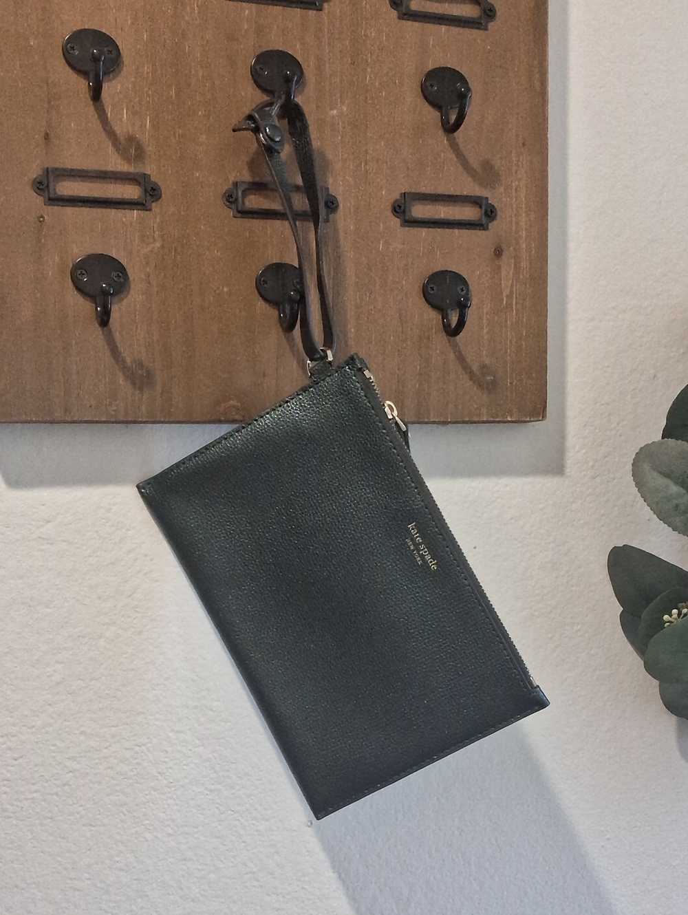 kate spade pebbled leather wristlet in dark green with gold logo